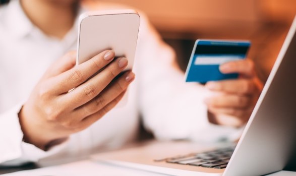 Woman typing debit card data